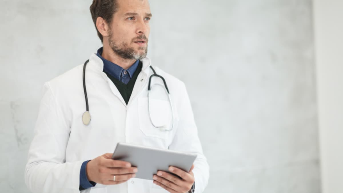 A doctor using a tablet in a hospital setting