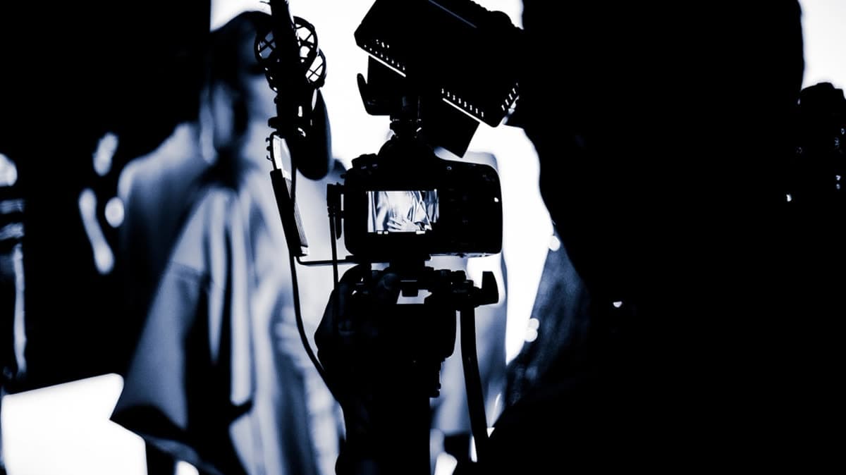 A camera operator filming in a production studio