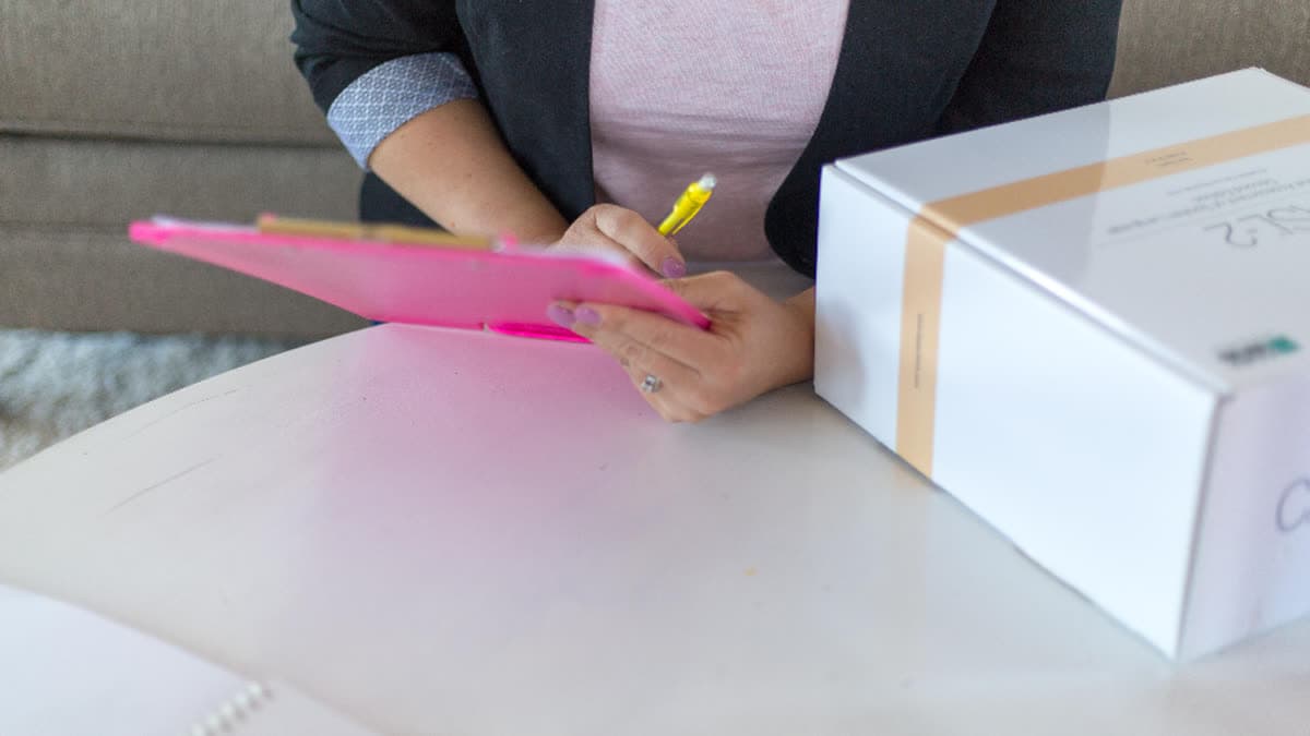 A person completing a checklist on a clipboard